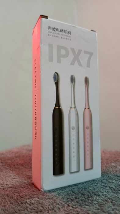 Электрическая зубная щетка