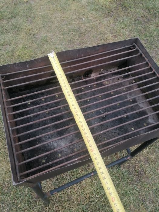 Grătar de inox, picioare de fier, 45x31 cm. 
Are lipsa o bara din gril