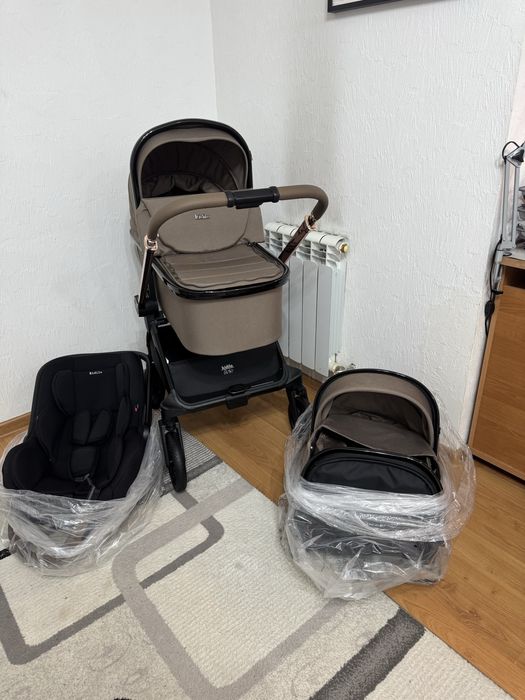 Kidilo Коляска 3в1. В комплекте рюкзак, дождевик, сетка от насекомых.