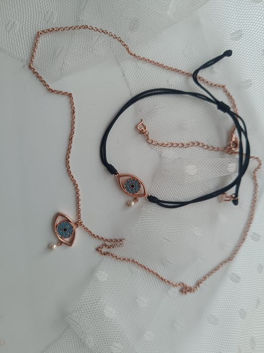 Комплект на Oxette колие и гривна в розово злато със синьо око