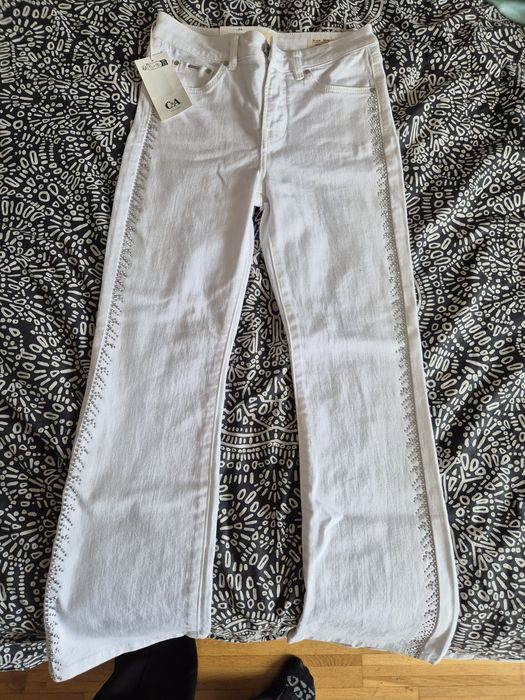 Бели дънки, ластична материя с метални шипчета(приличат на камъчета)и