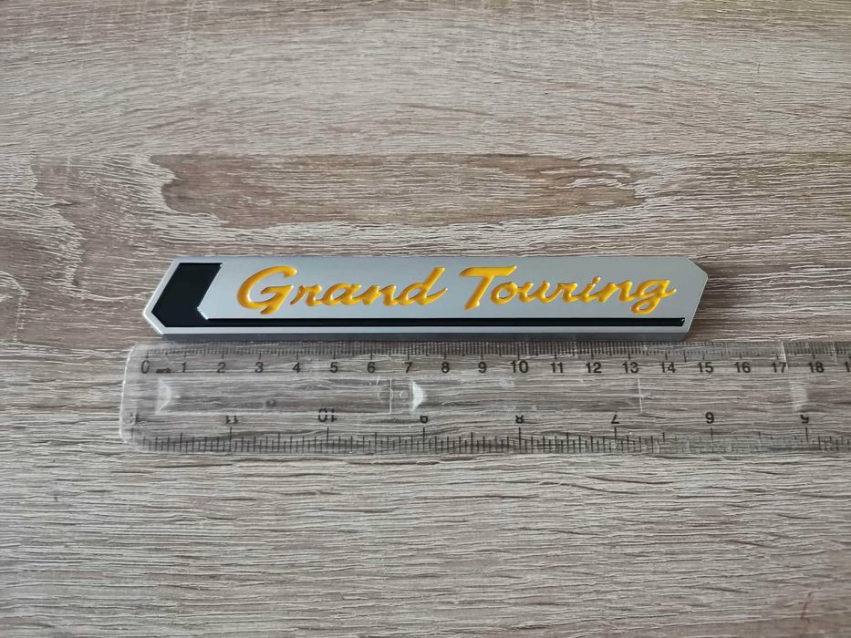 Емблема Toyota Grand Touring