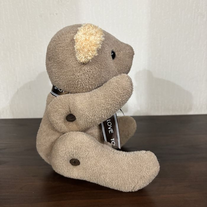 Плюшевый мишка с движущимся лапами