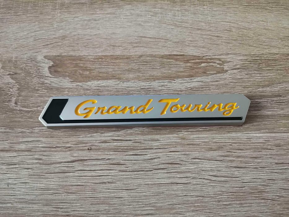 Емблема Toyota Grand Touring