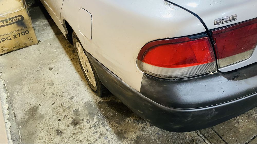 Задний бампер Mazda Cronos