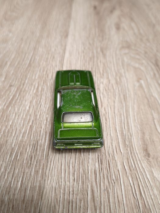 green Hot Wheels 1:64 scale Plymouth AAR Cuda, specifically a 2008 rel