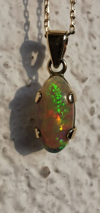 Опал от Етиопия 4,14 карата.Златен обков и ланец