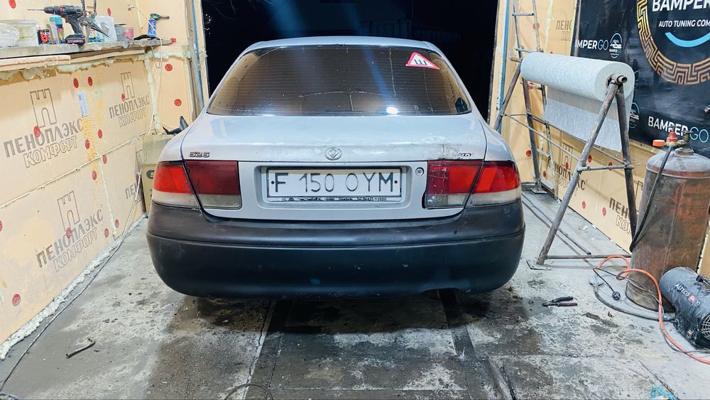 Задний бампер Mazda Cronos