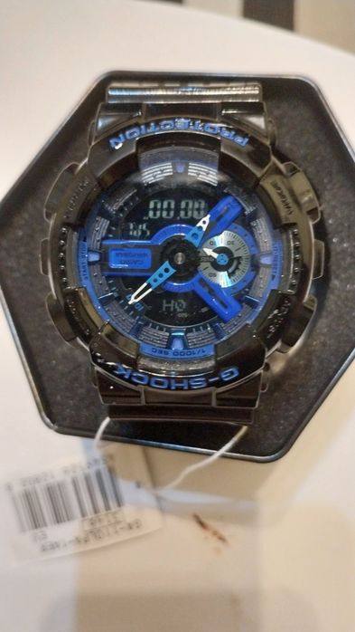 Vând ceas Casio G-Shock GA-110LPA-1AER, model cu cadran verde măsliniu/negru și accente albastre (design inspirat militar).