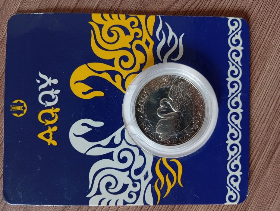Монета Акку в блистере