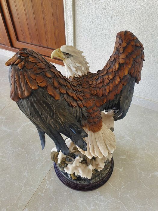 Статуя орла на деревянной подставке