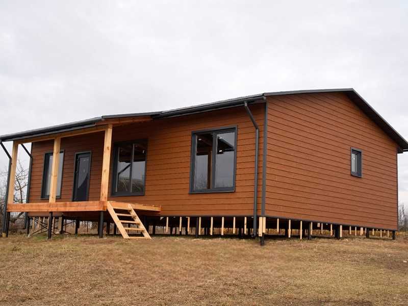 Сайдинг Карьяла под дерево. Металлочерепица, софиты, водосток.