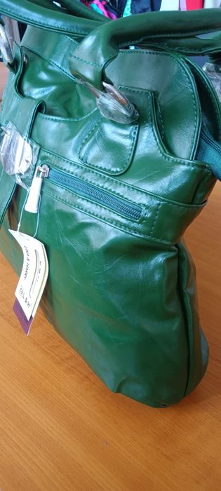 Дамска чанта от зелена еко кожа с къса и с дълга дръжка и ефектна катарама.Разпределението вътре е от две отделения и преграда с цип в средата