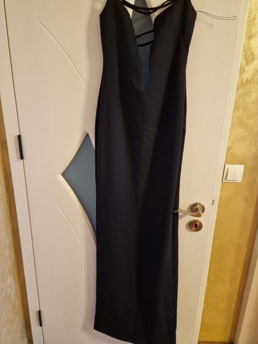 Елегантна черна рокля с изрязан акцент и фини презрамки.