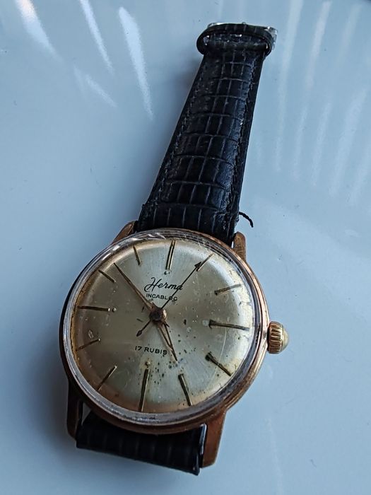 Ceas Herma Placat cu aur Int. Manuala Funcționează excelent!