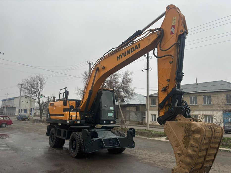 Колесный экскаватор 210