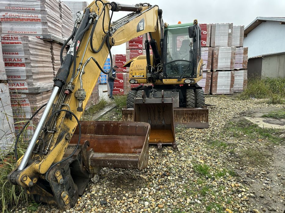 Vand excavator pe pneuri Cat M313D