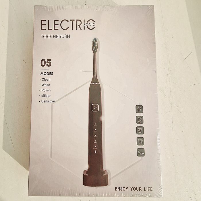 Электрическая зубная щетка