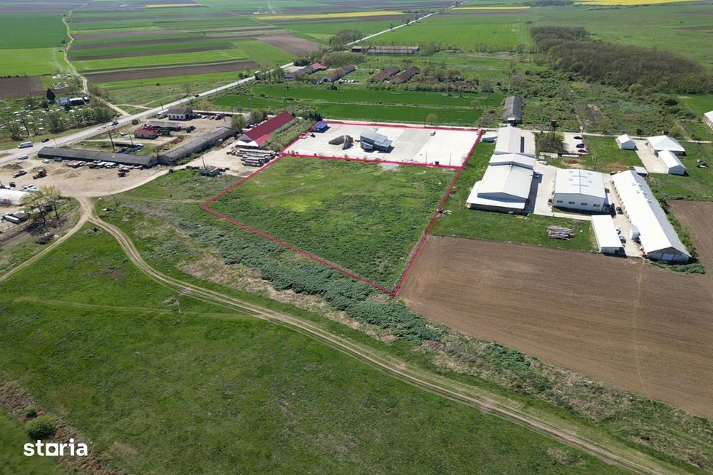 Teren industrial, betonat  si imprejmuit cu utilitati si vad comercial