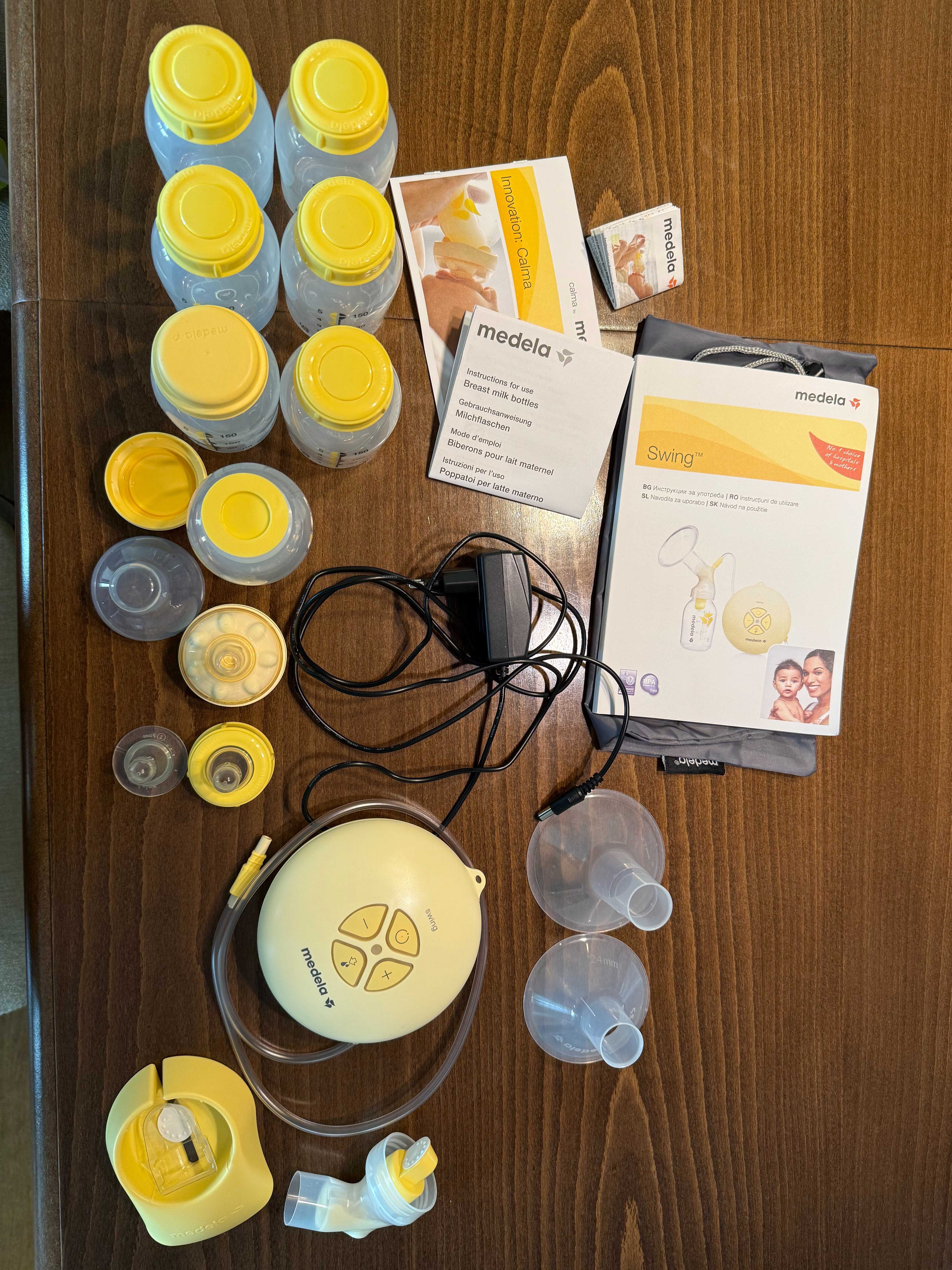 Електрическа помпа за кърма Medela Swing с аксесоари и 7 шишета