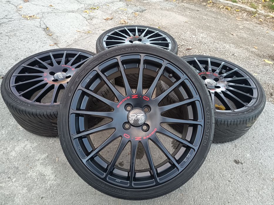 Джанти OZ оригинални 18" 4x100 черен мат с червено с гуми 215/35/18