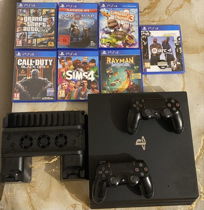 PS4 Pro 1TB + 2 контролера + охлаждаща стойка с зарядно + 7 игри