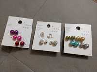 Различни видове чифт обеци с камъчета или цветни перли