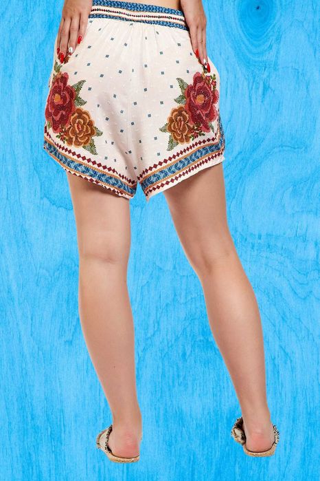 Pantaloni crem cu print floral caramiziu