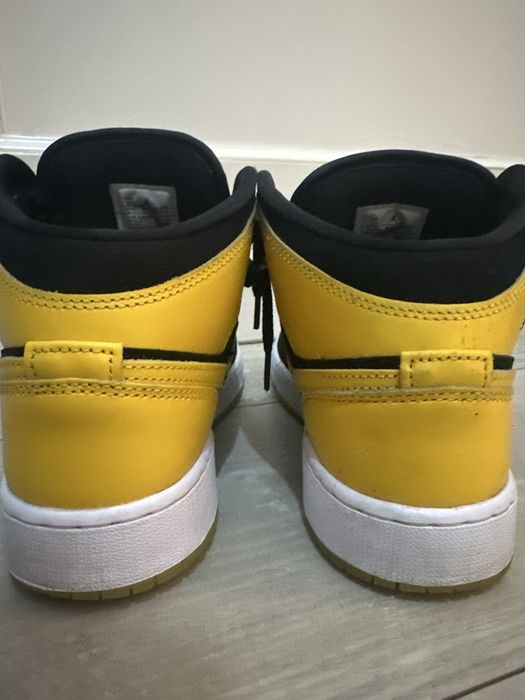 Air Jordan 1 Mid SE in a black and yellow colorway.