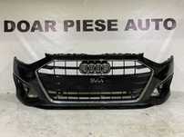 Bara fata Audi A4, B9, facelift, 2020, 2021, 2022, 2023, 2024, cod origine OE 8W0807437AH, cu gauri pentru senzori de parcare. Grila are o dunga pe crom.