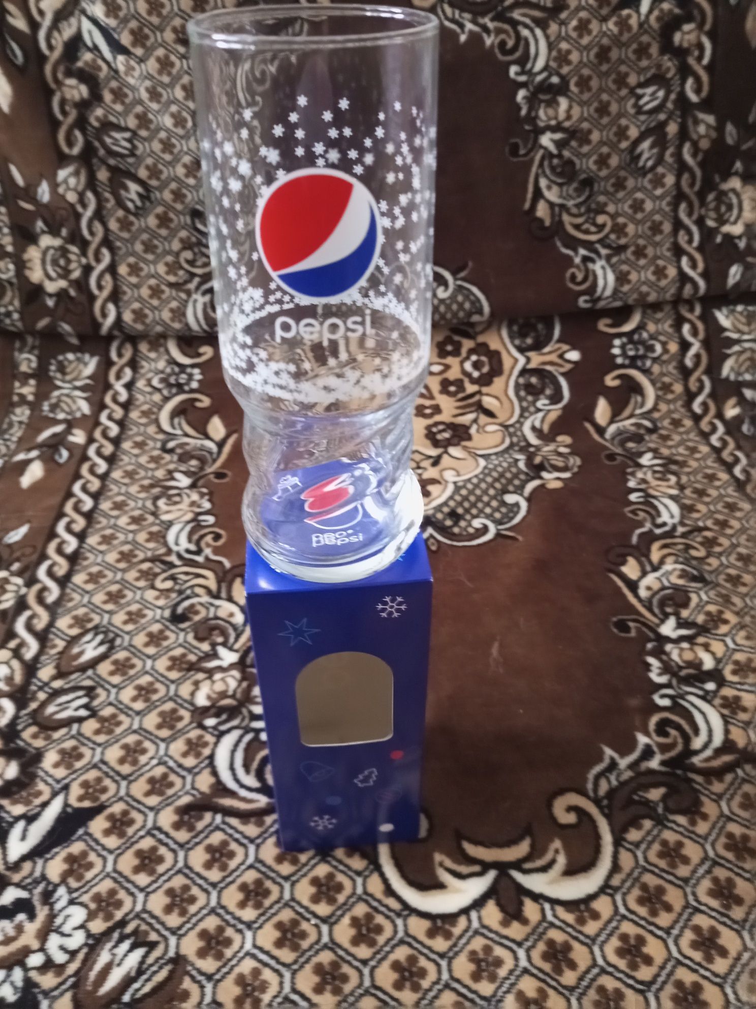 Секлянный стакан с логотипом Pepsi.