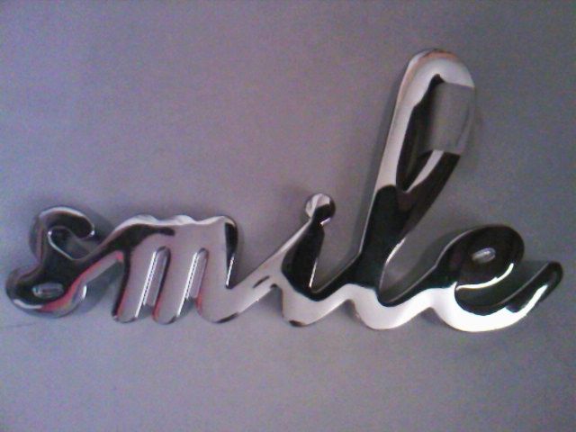 Veverita: suport metalic cromat pentru inele, ornament "smile" Next UK