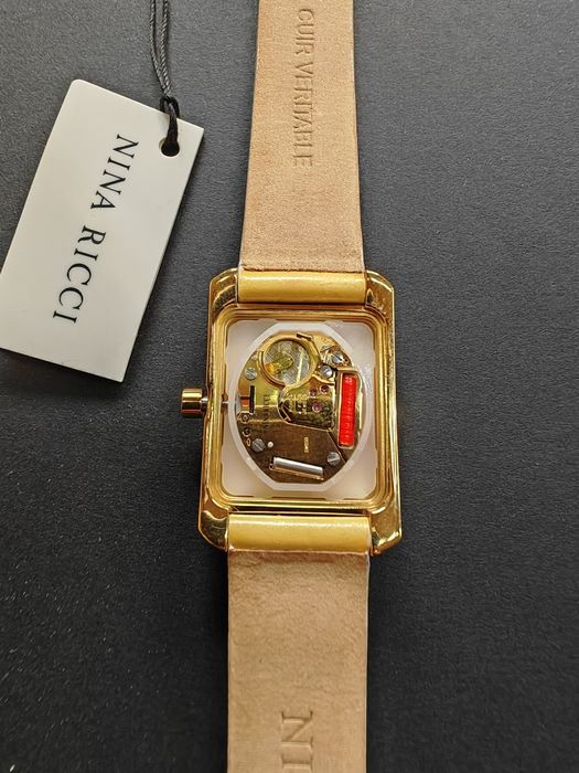 Ceas de dama Nina Ricci  auriu cu cadran alb original, nou  fără cutie