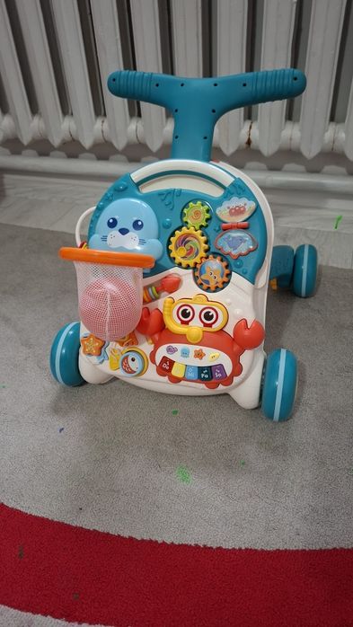 Ходунка каталка и развивающии столик 2в1