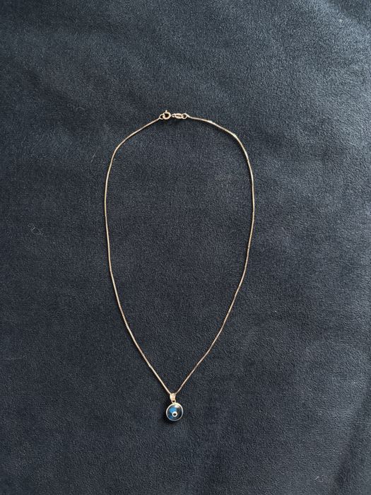 Сребърно колие със синьо око против уроки