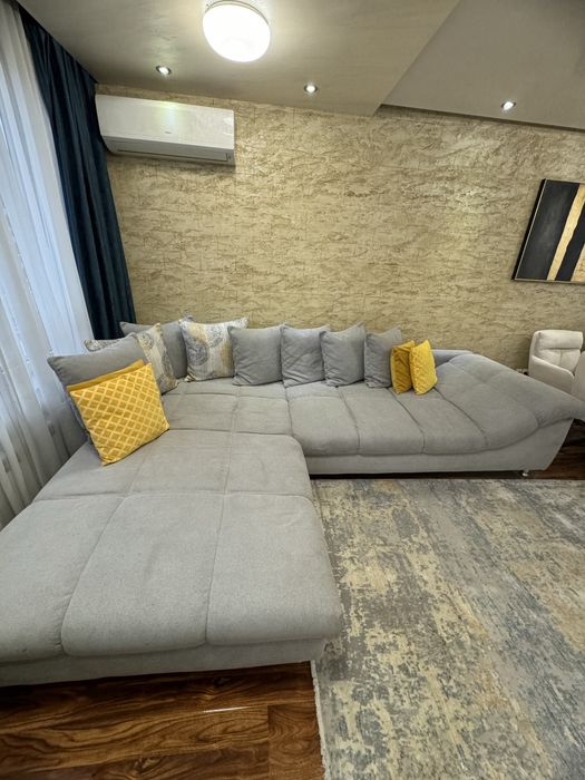 Сив ъглов диван с декоративни възглавници