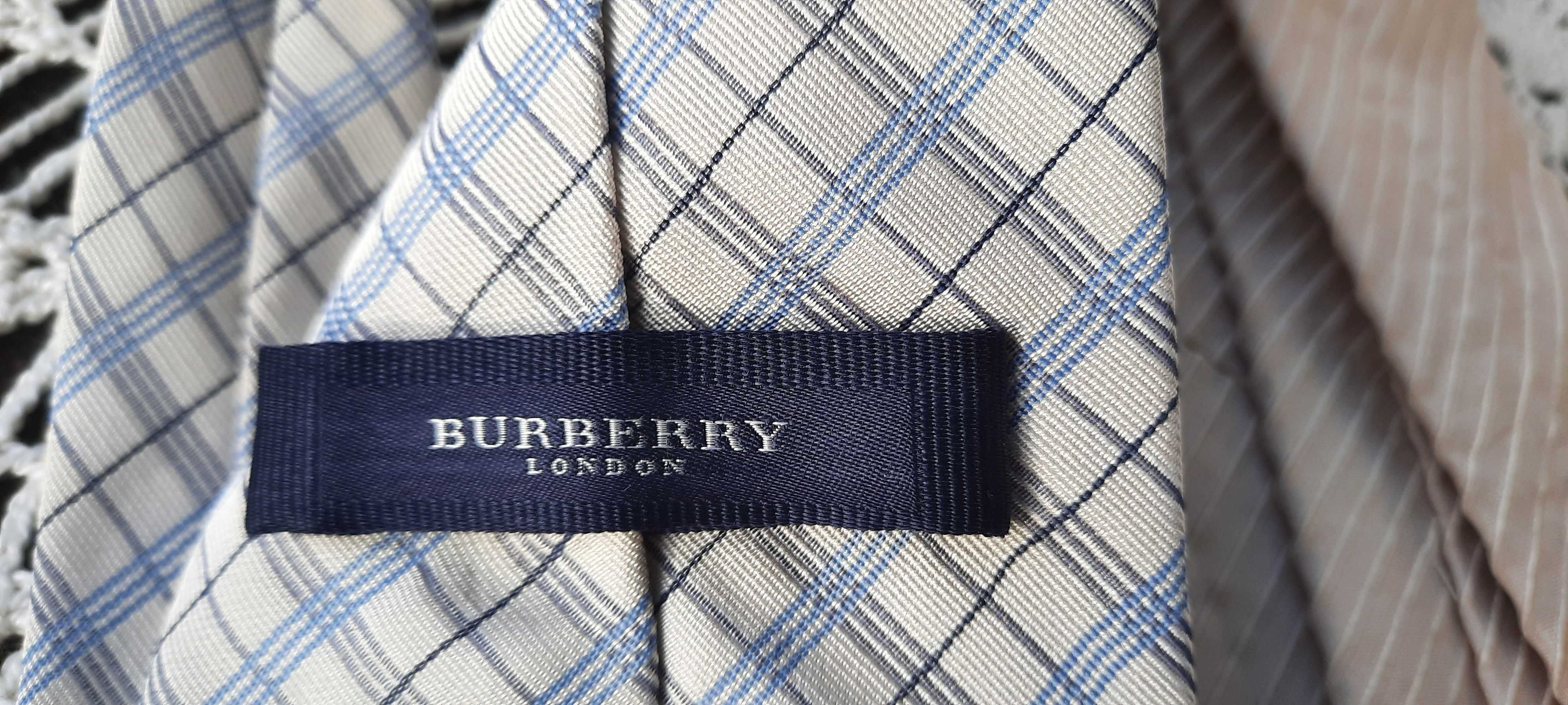 vand două cravate din mătase, una este marca Burberry.