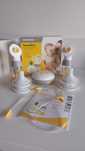 Двойна двуфазна помпа Medela Swing Maxi + допълнителни аксесоари