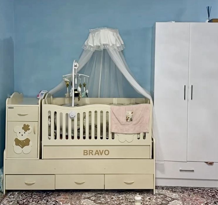 Detskiy krovat, ichida bortik, pardasi, va aylanadigan uyinchoqlari