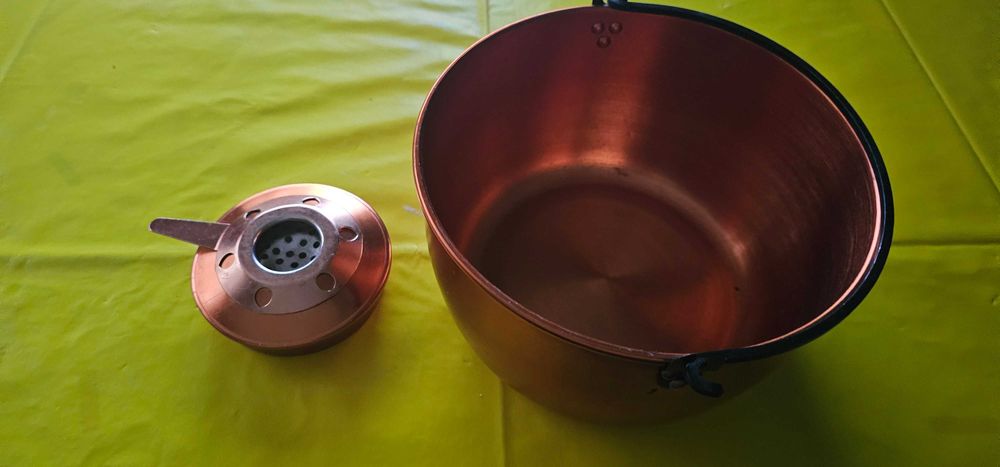 vas de cupru și un arzător cu spirt gatit in natura drumetii