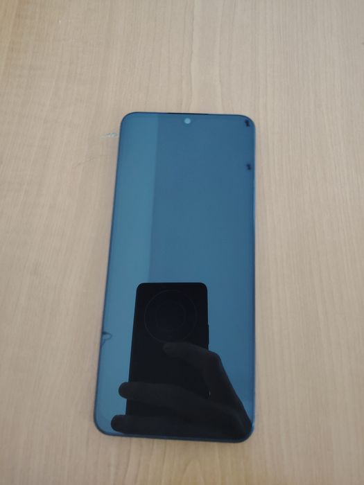 Redmi 14 c spart pe spate, dar în stare foarte bună de funcționare