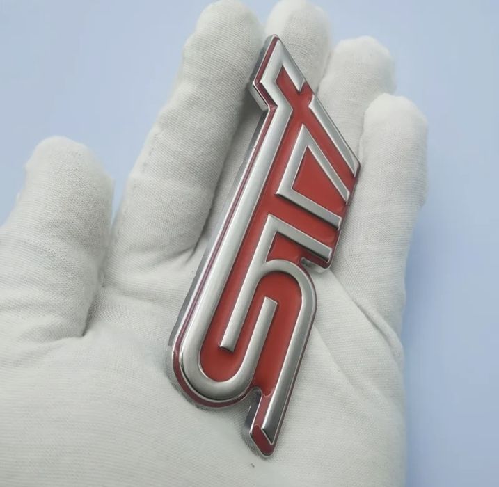 Memaʌнa емблема STI за Subaru.
Ipogykma e om Hau-Bucok kʌac.