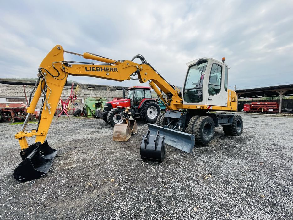 Excavator Liebherr A 311 pe roti Cupa + Greifer -Import Germania