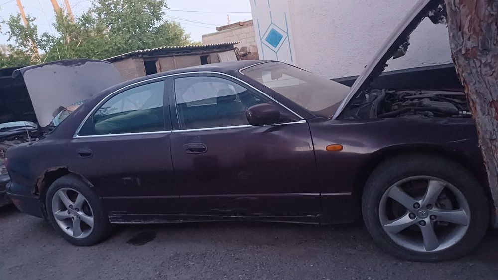 Продам по запчастям Мазда Кседос 9.