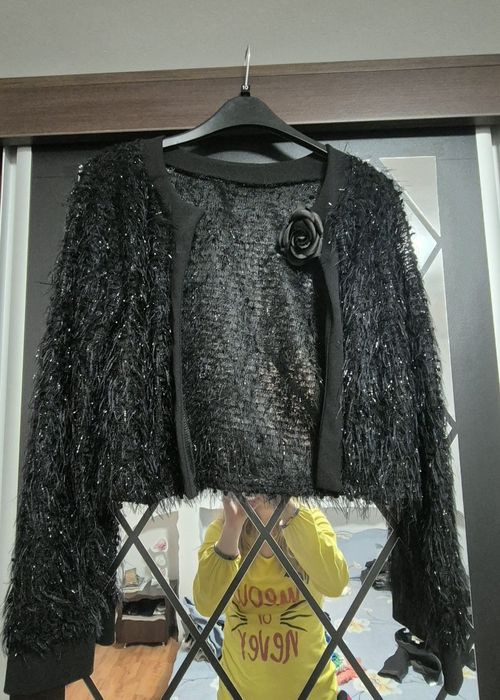 Jachetă bolero neagră, cu o aplicație florală.