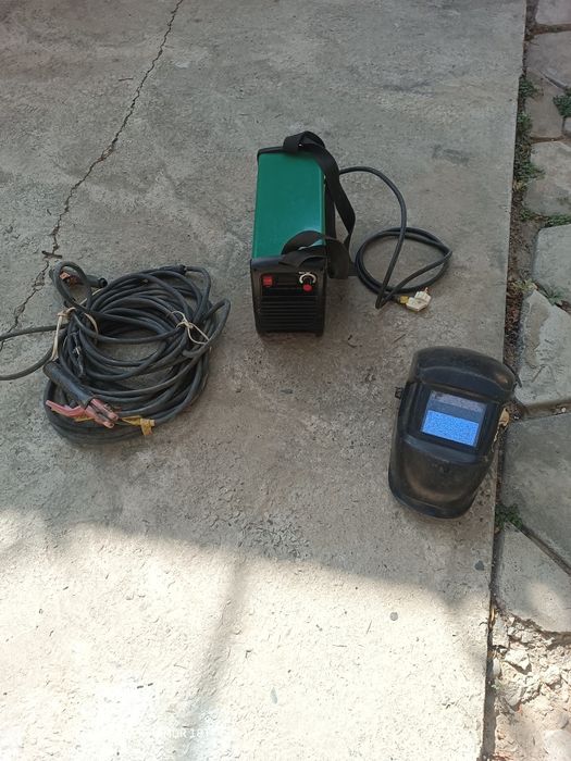 Электросварочный аппарат с кабелями и маской.