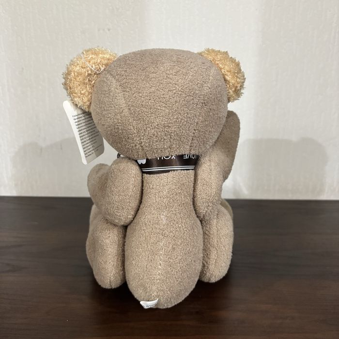 Плюшевый мишка с движущимся лапами