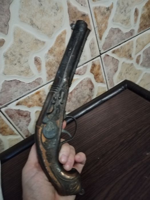 Obiecte de colecție cu foite de aur și pistol din bronz