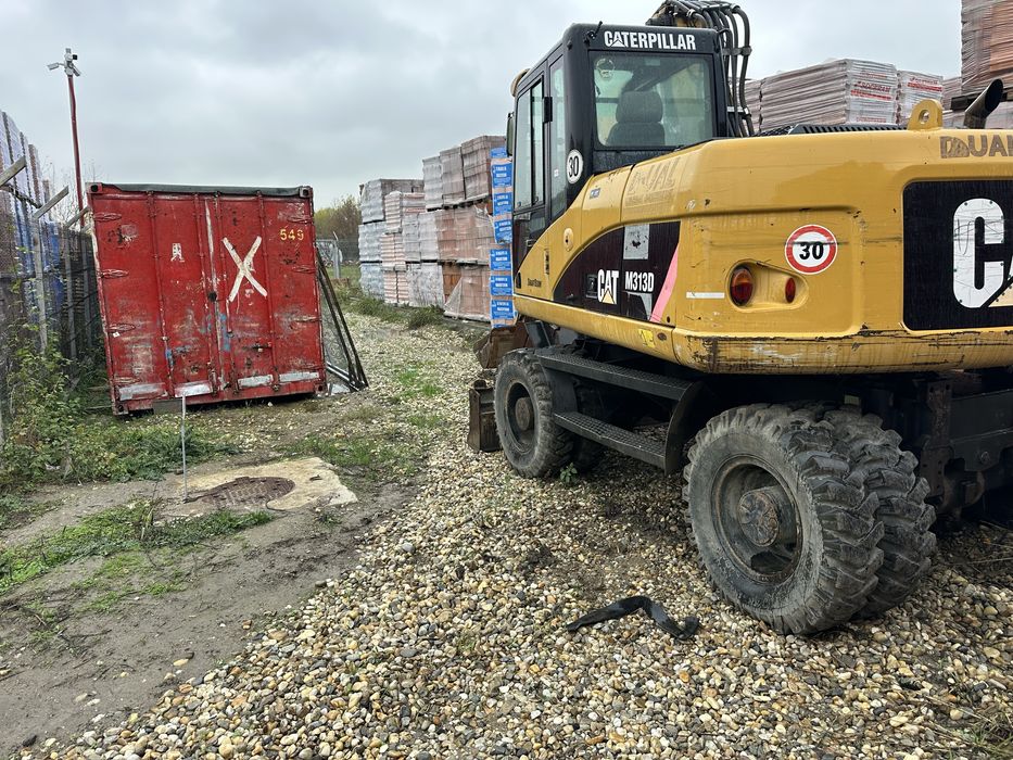 Vand excavator pe pneuri Cat M313D
