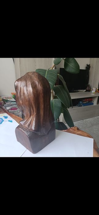 Sculptura de lemn , femeie cu batic .